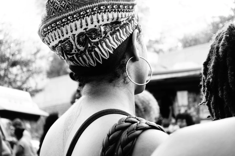 a man is wearing a knitted hat and some other people