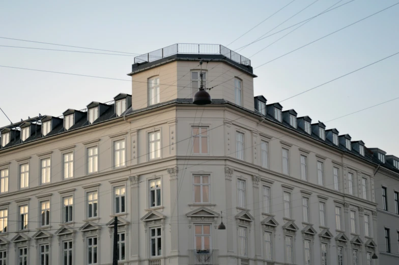 a large white building with lots of windows and a clock