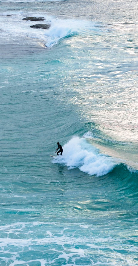 a surfer surfing the crest of a large wave