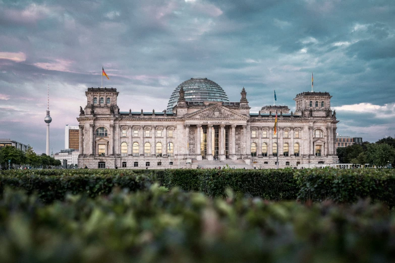 an old building with many windows under a cloudy sky