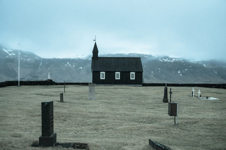 a church on a cloudy day with a cross on it