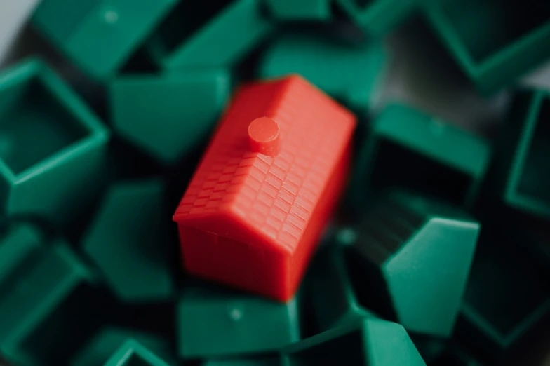 a tiny red object on top of green squares