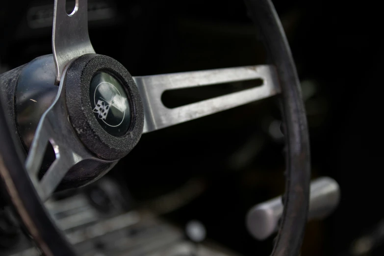 the steering wheel and dashboard of an old car