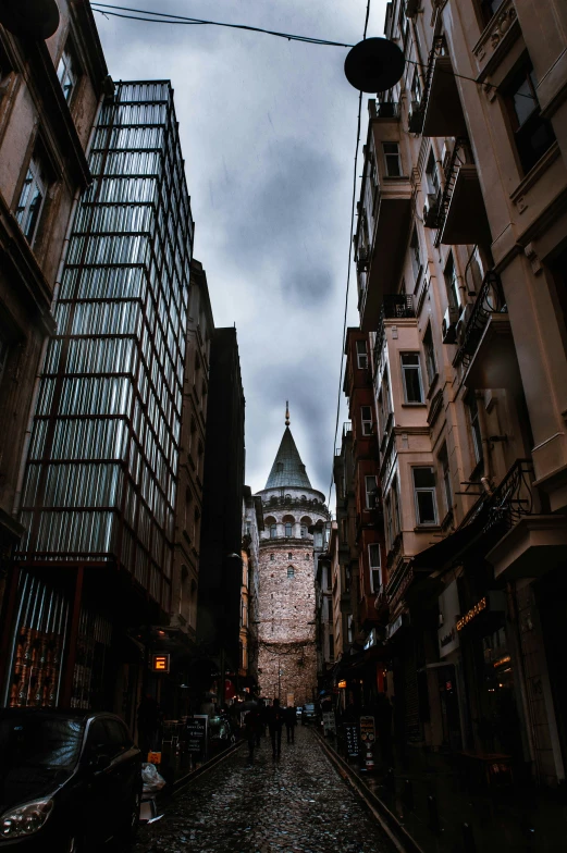 tall building in an alley with cobblestone pathway