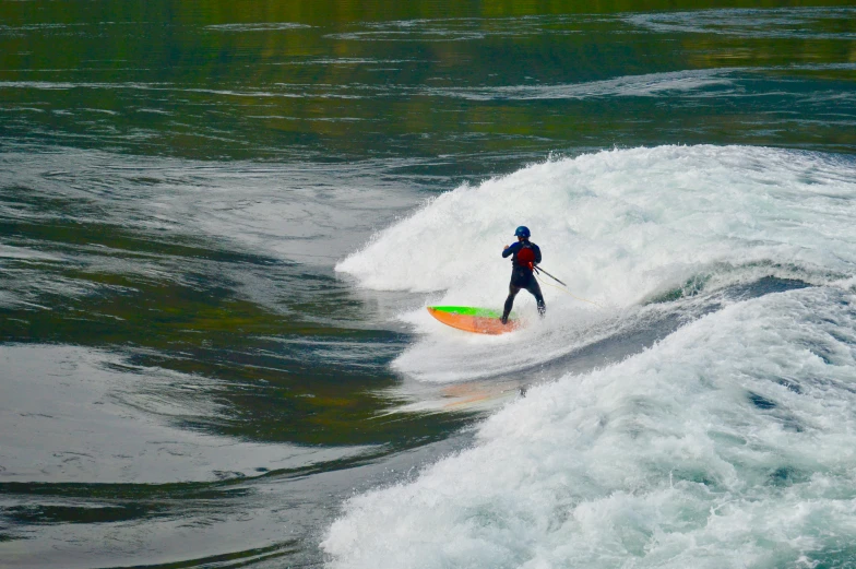 a surfer is riding the waves while holding a paddle