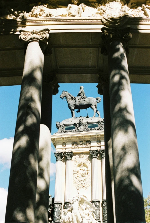 a tall stone building with a statue in the middle