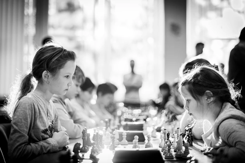 girls playing chess on large chess boards in the dark