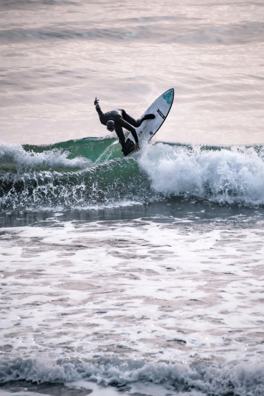 a surfer riding an ocean wave with his surfboard