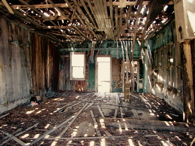 a empty, run down room is shown with wooden beams