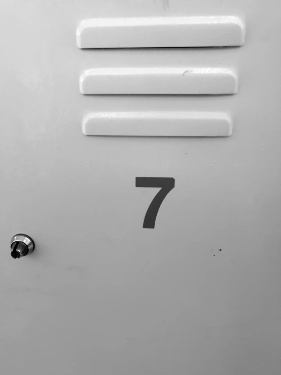 a white door with a four - letter numeral sign next to it