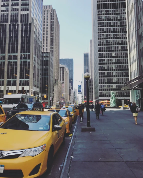 taxis line the street in front of large buildings