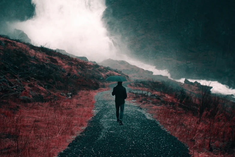 a man standing in the middle of a road surrounded by storm clouds