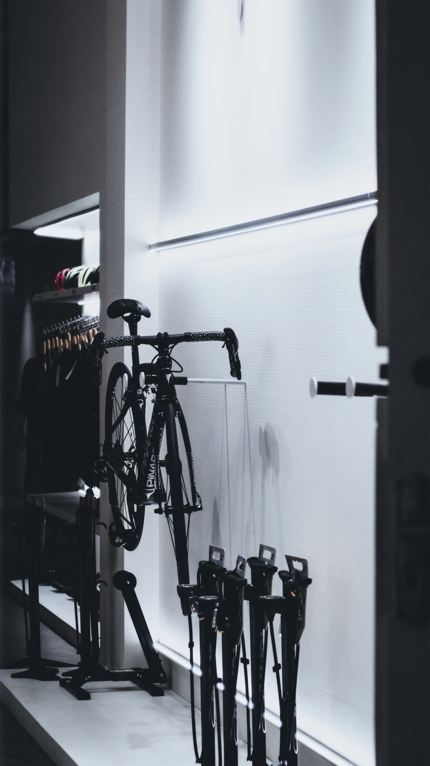 several bike leaning against the wall on display