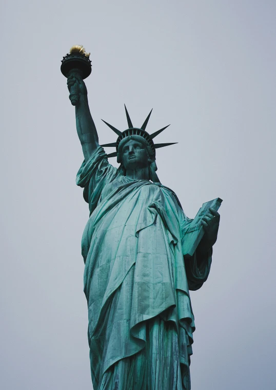 the statue of liberty with a small bird in its hands