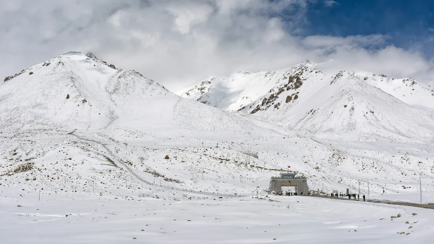 a snowy mountain with houses in the snow