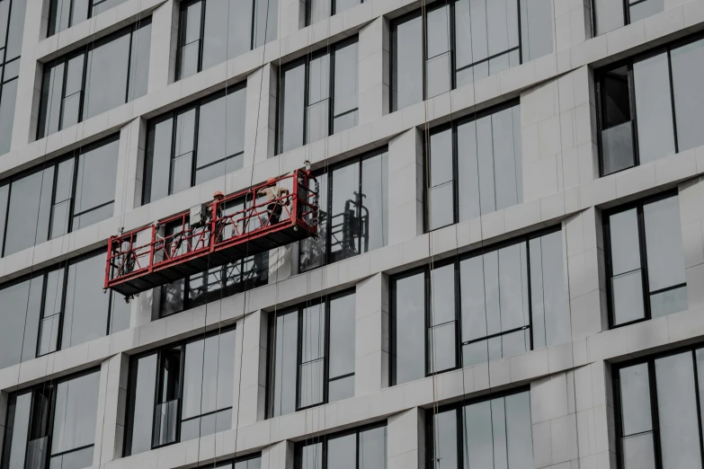 the windows are being repaired by a company's workers