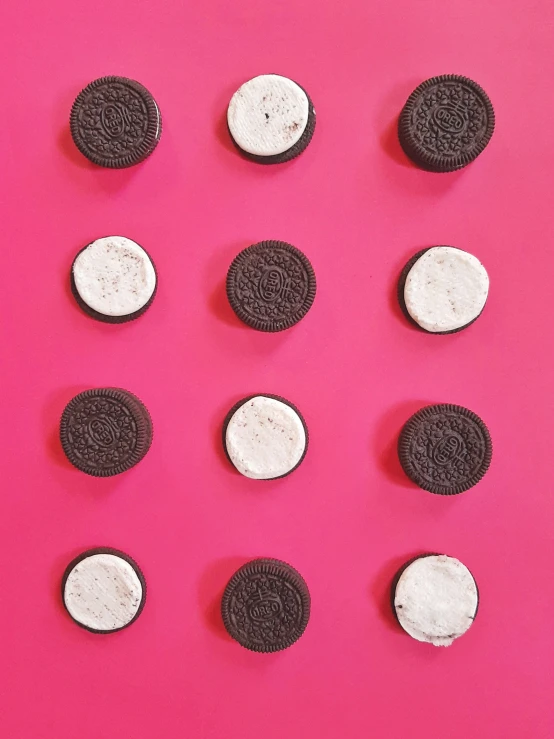 several oreo cookies are shown together on a pink surface