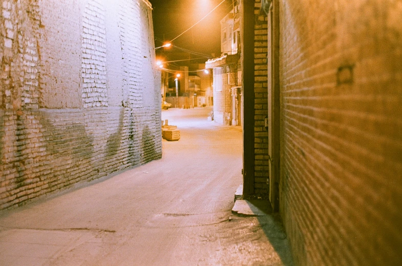 there is a alley way leading into a brick building