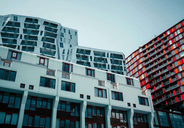 a multi story building with multiple windows in front of it