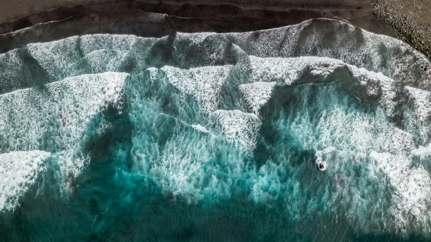 people in a kayak floating in an ocean near the shore