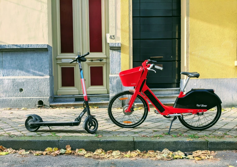 a red bicycle with an enclosed basket parked on a curb