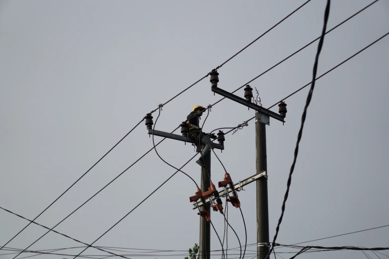 an electrician working on a power line during the day