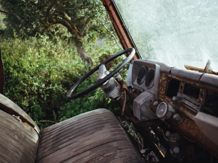 the interior of an old tractor looking abandoned