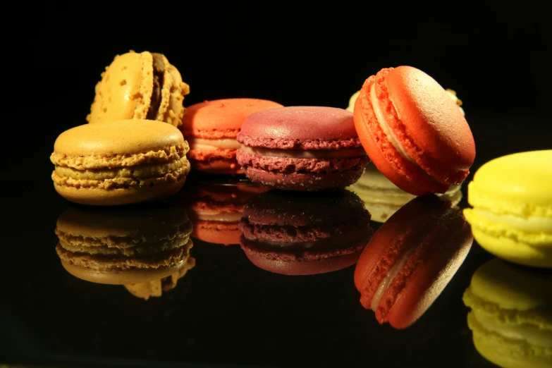 a table topped with a bunch of different colors of cookies