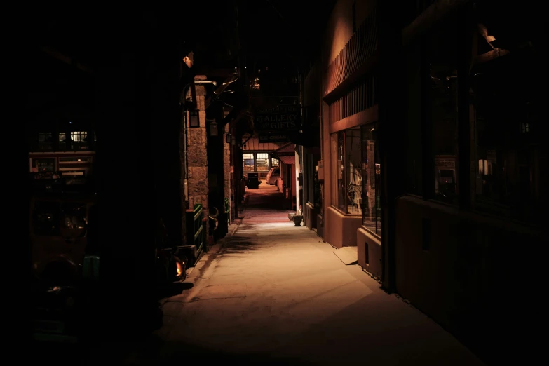 an alley way at night with only lights on