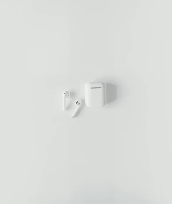 an airpods attached to the wall, and two smaller ear buds