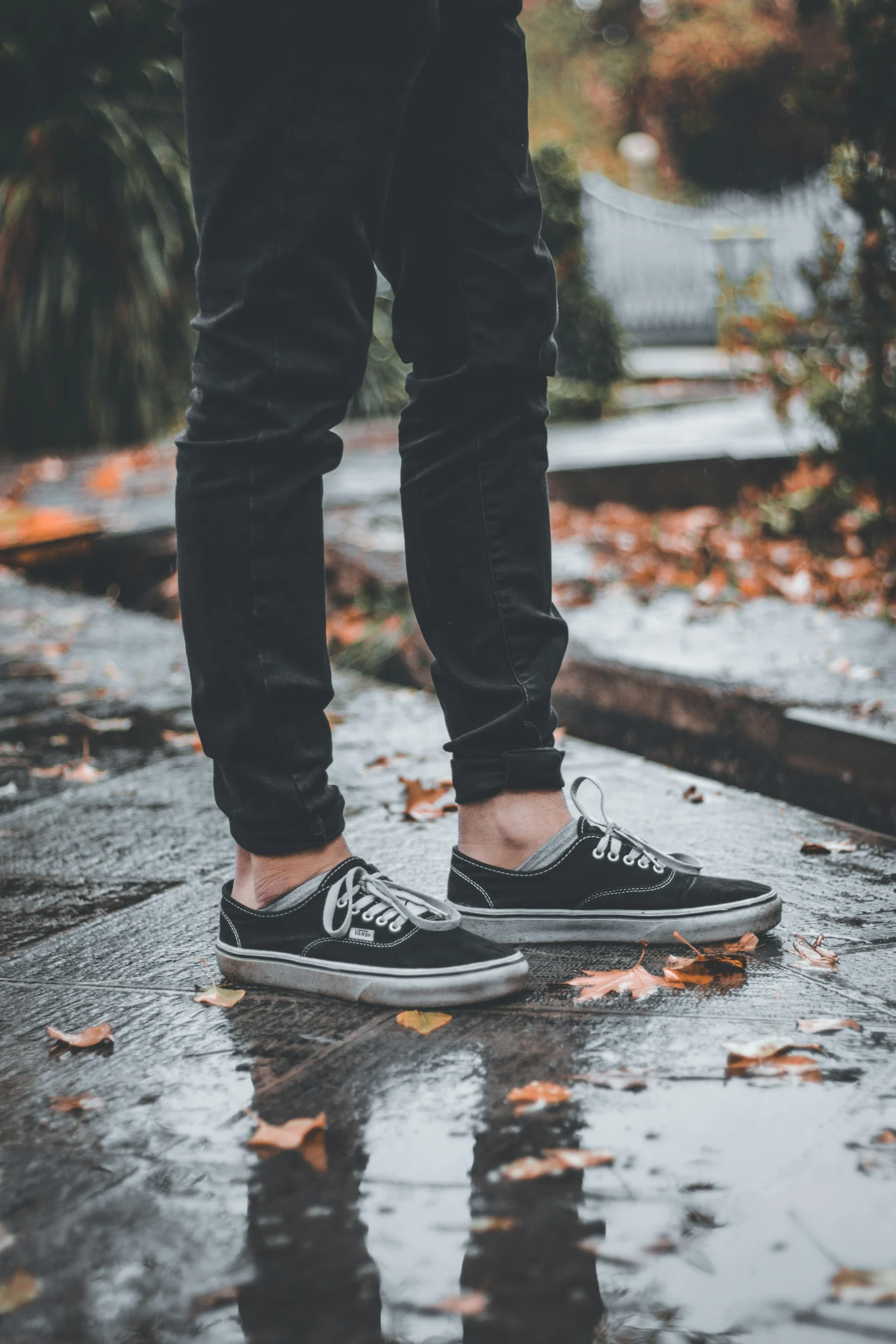 the feet of a person who is standing on top of a wet floor