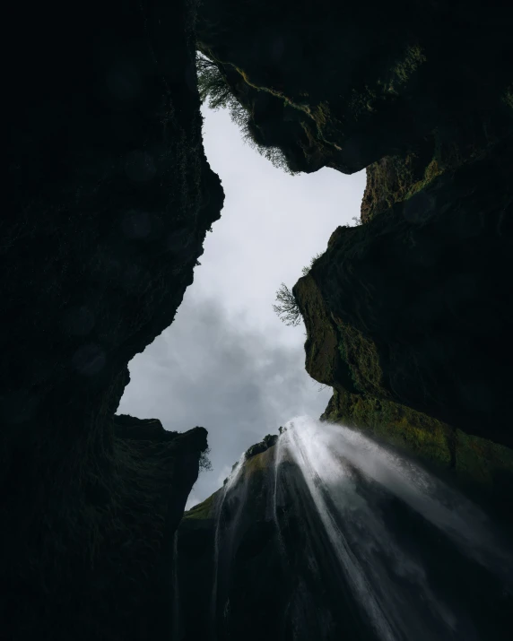 sunlight shining through the hole on the rocks in the ocean