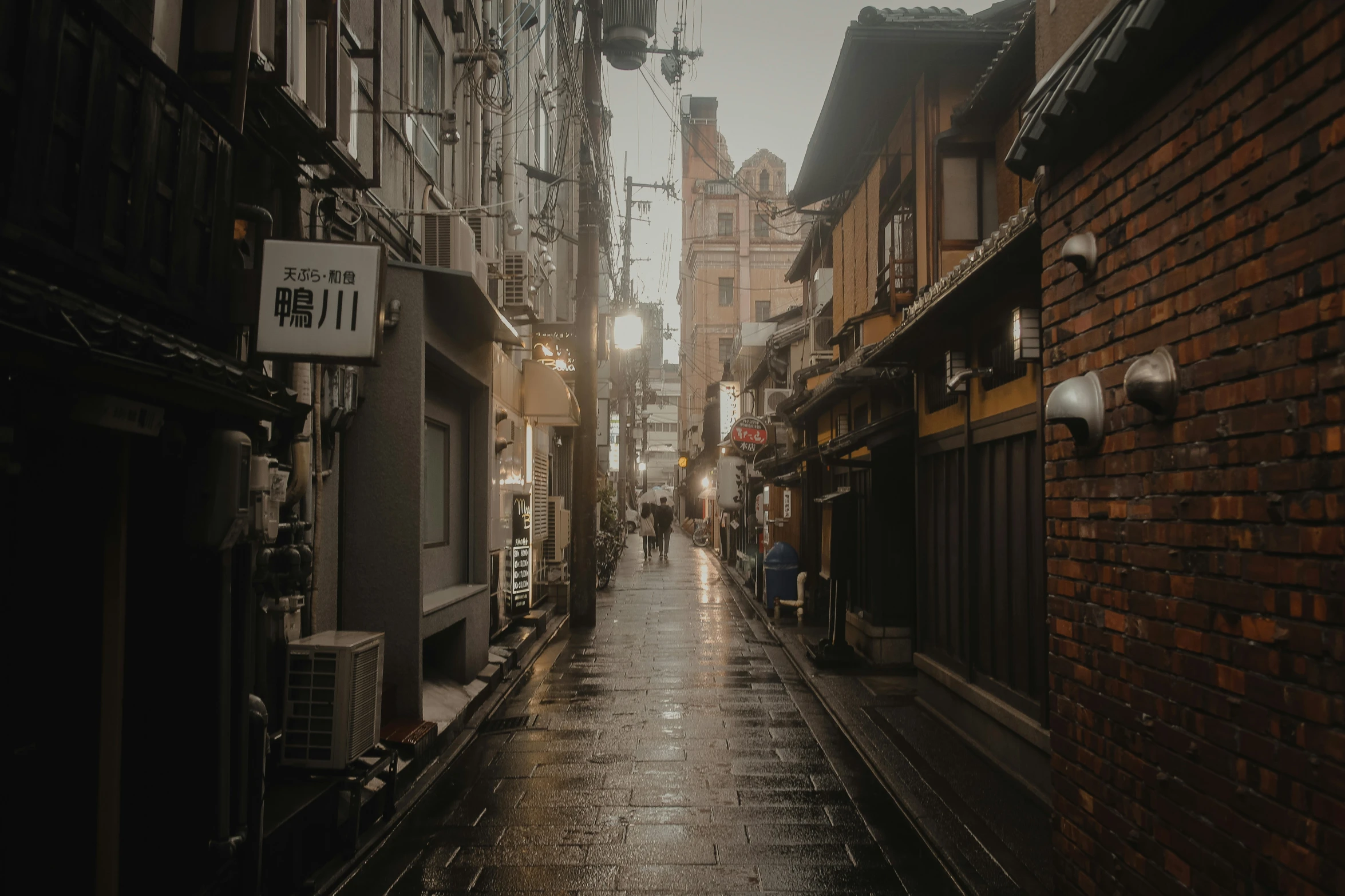 an alley leading into a city at sunset