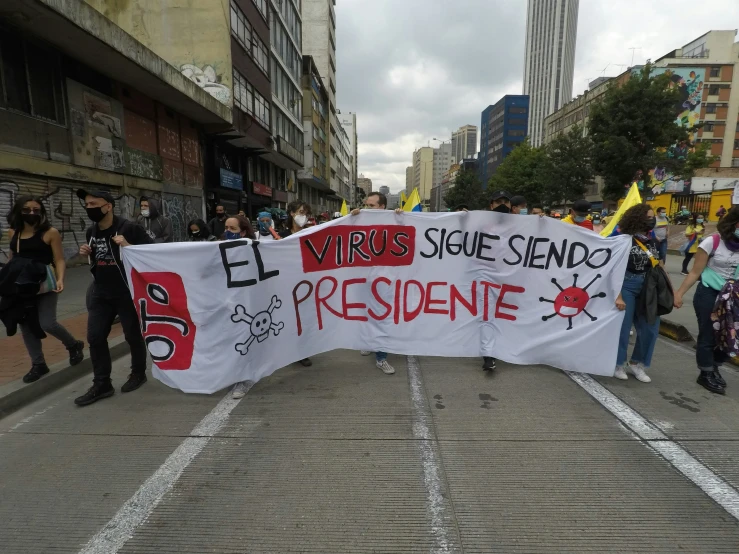 a man holding a political sign at a rally