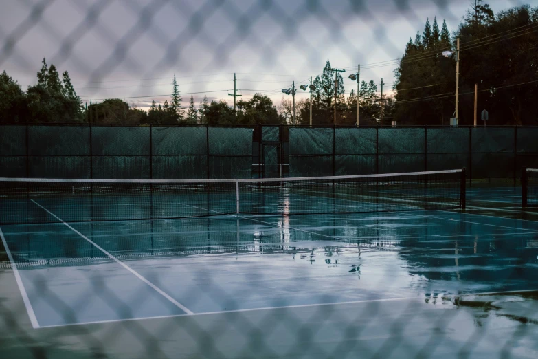 tennis court in background with chain link fence