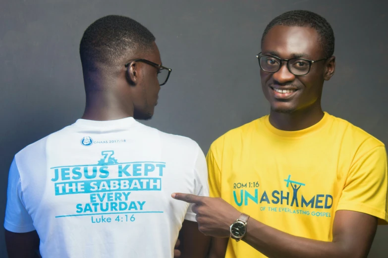 a man and another man in plain shirts posing for the camera