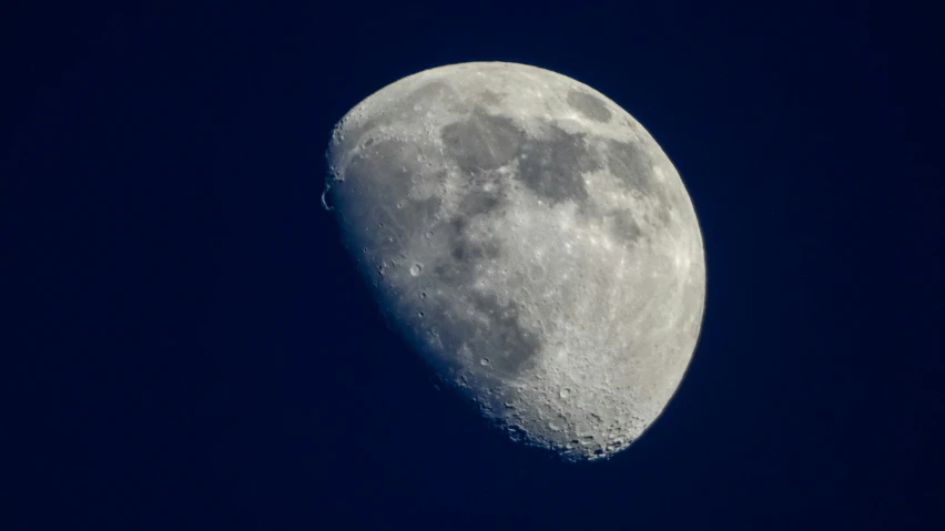 a crescent moon appears in a dark blue night sky