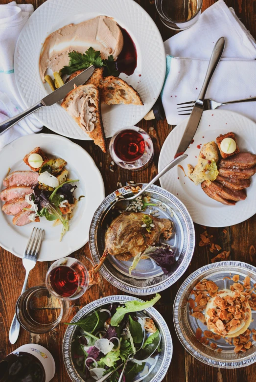 plates and glasses sit on the table top with food