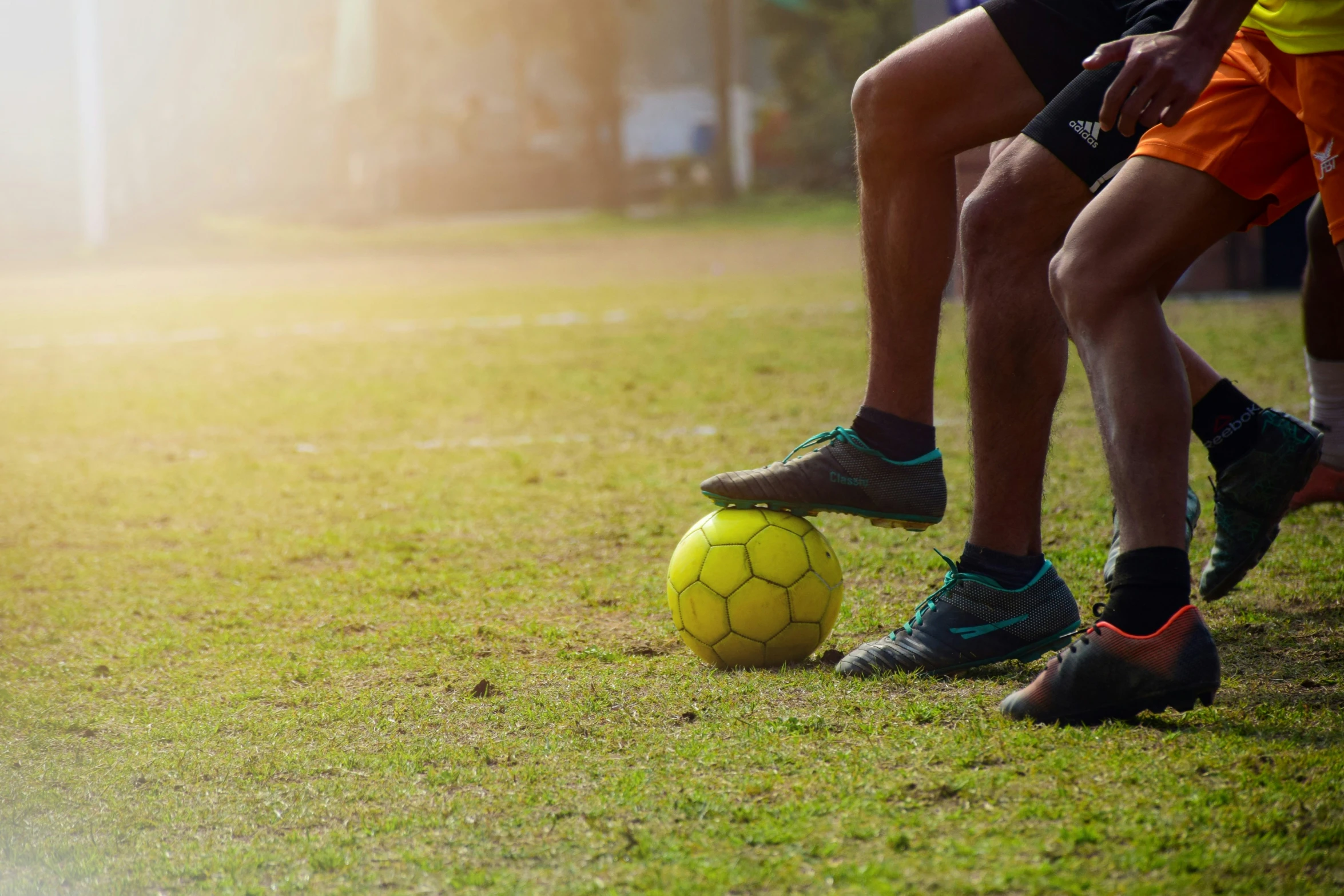 three men running with soccer balls in their hands