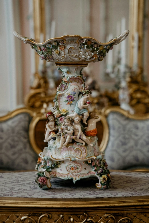 ornate porcelain figurines are decorated on a decorative stand