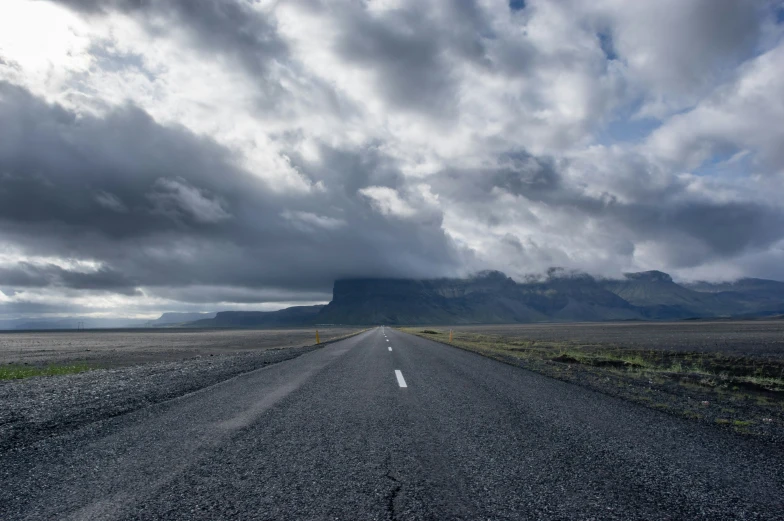 clouds and rain over the sky over a road