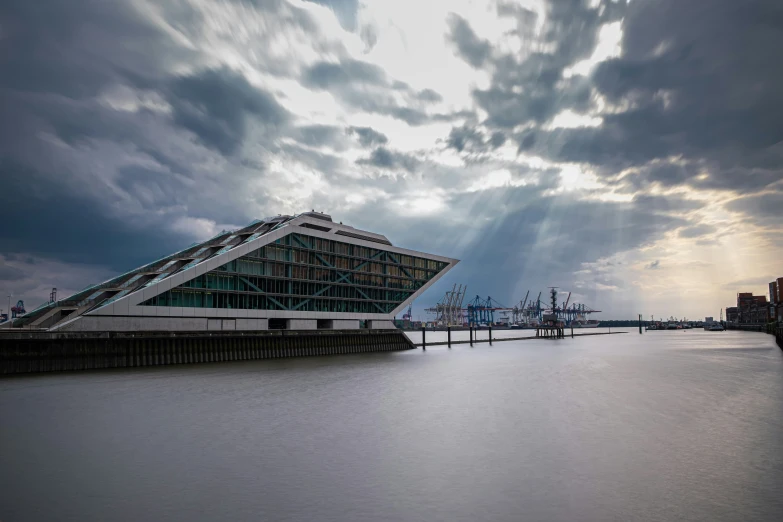 there is an unusual building sitting next to the water