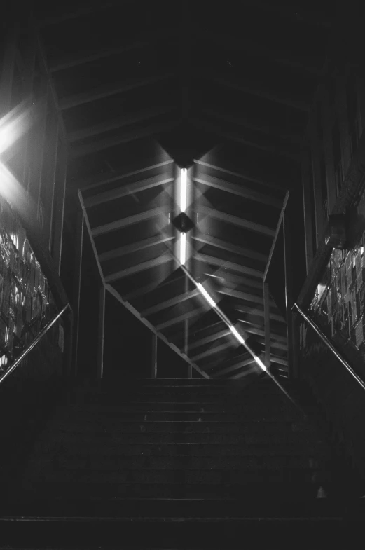 a dark alley at night with lights and stairs