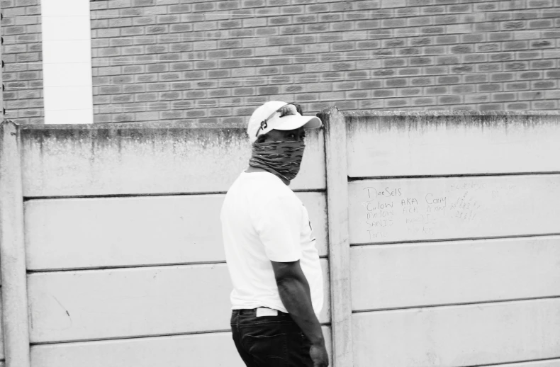 black and white po of a young man with hat on