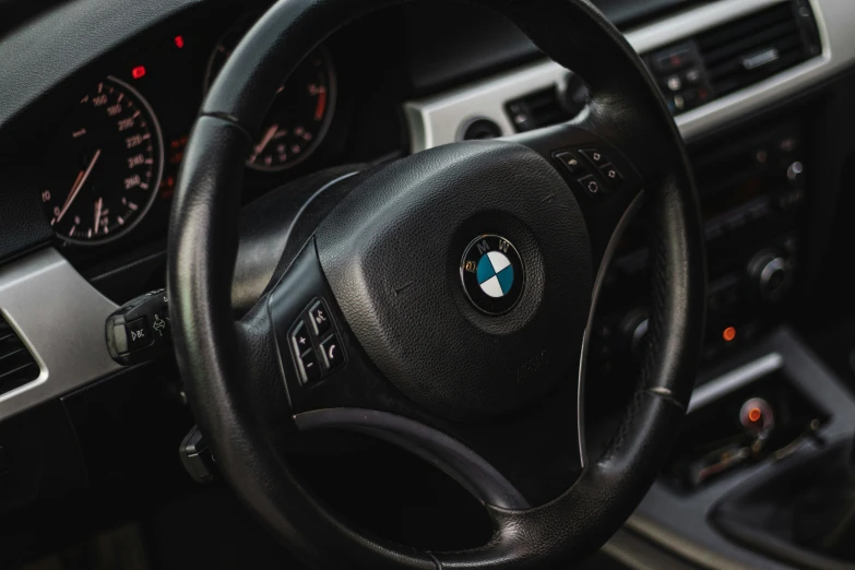 the steering wheel of a bmw car with dashboard lights