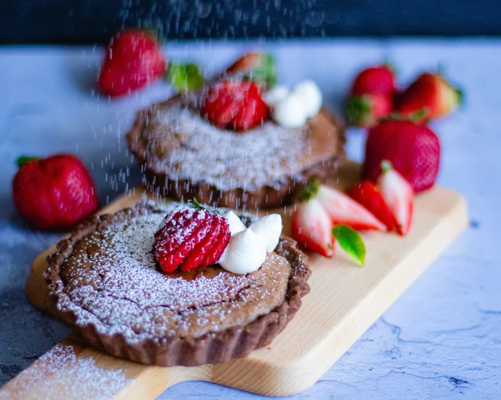 a pastry with fruit on the top next to another pastry