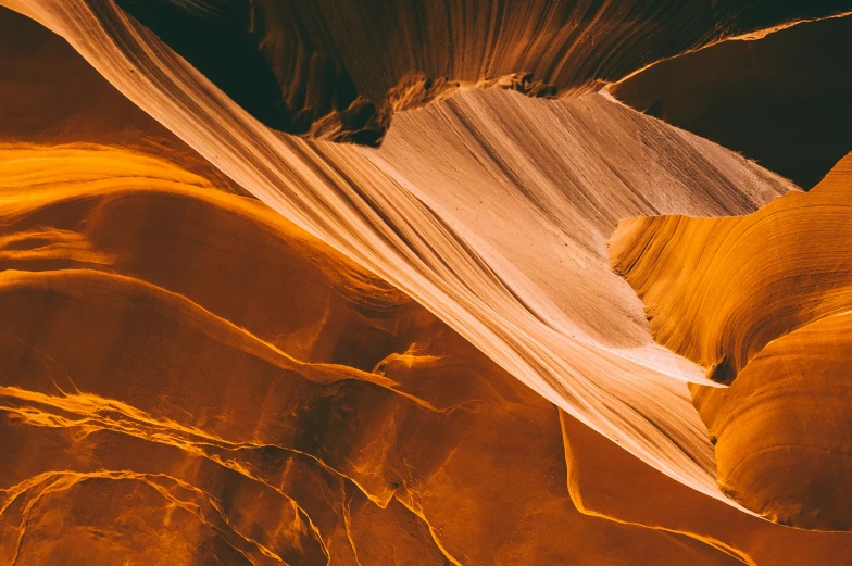 yellow light coming through the wall of a canyon