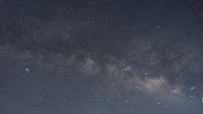 some stars on the night sky with a hill in front