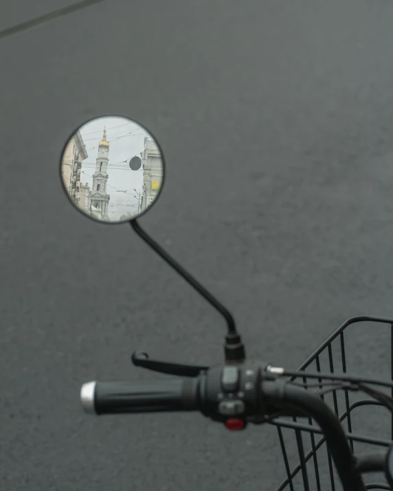 closeup view of a mirror of a bike on street