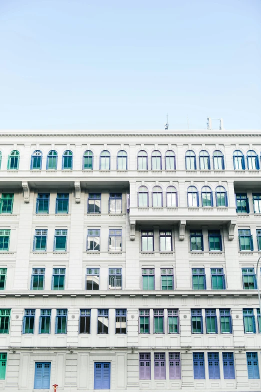 an old building has many blue and purple shutters